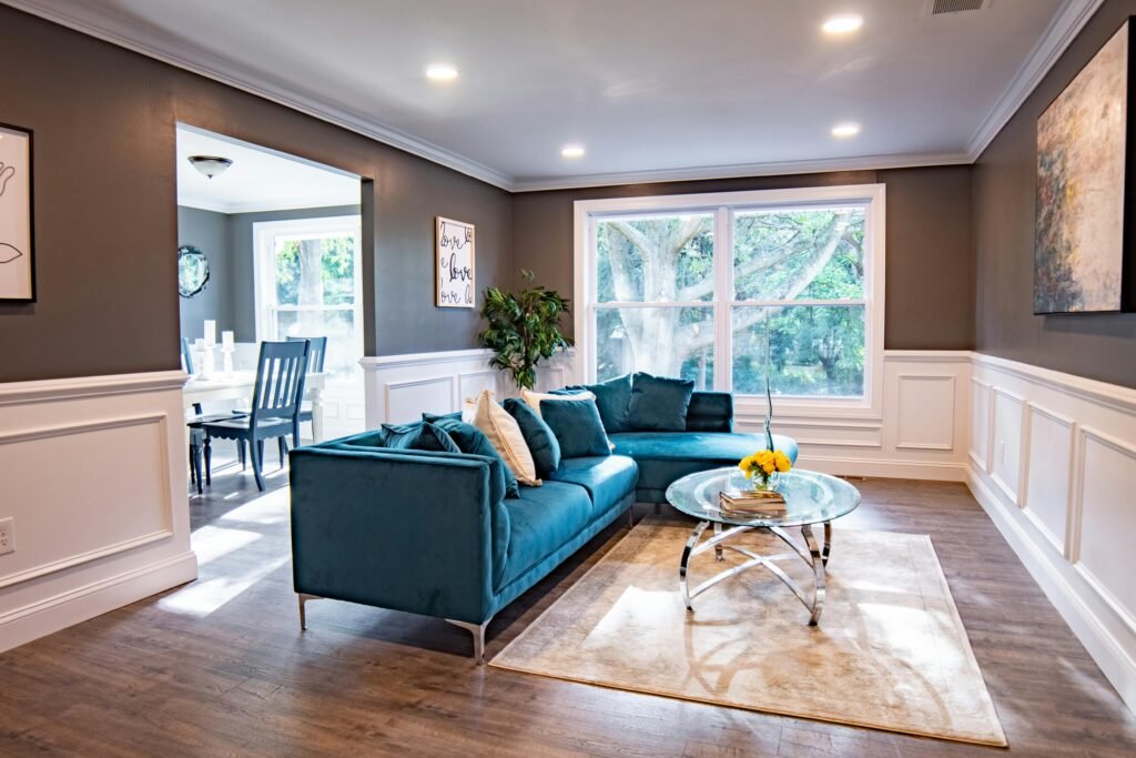 pexels-photo-8927352-8927352 Bright modern living room featuring a turquoise sofa and a stylish decor.